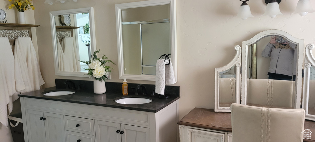 Bathroom with a shower with door and double vanity