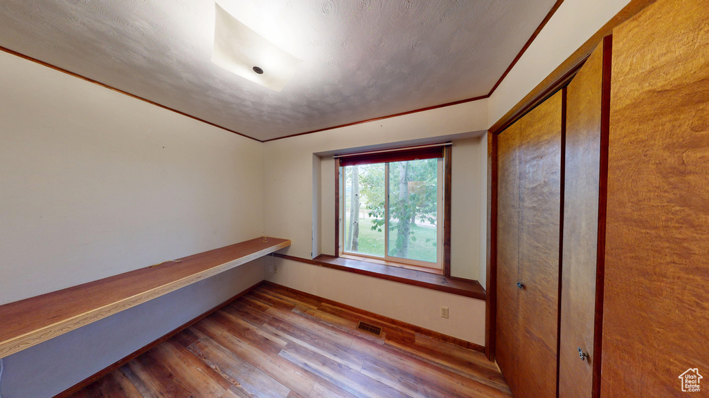 Unfurnished room featuring wood finished floors and baseboards