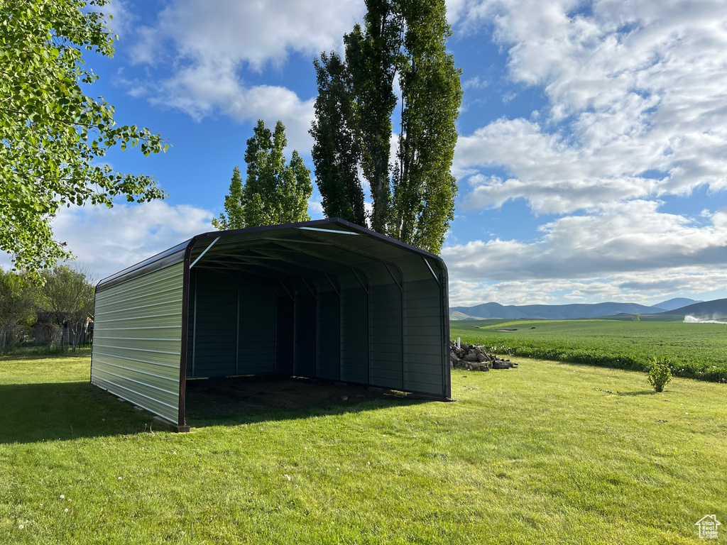 View of outbuilding with a detached carport and a mountain view
