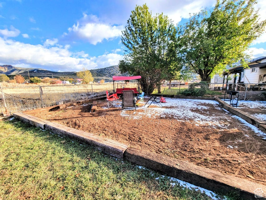 View of yard featuring fence and a mountain view