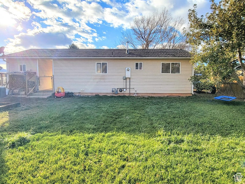 Rear view of house featuring a yard
