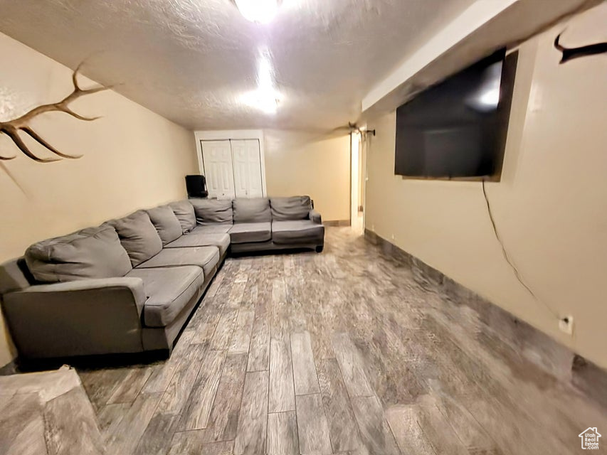 Living area with wood finished floors and a textured ceiling
