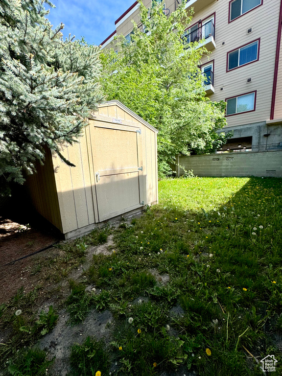 View of yard with a storage shed and an outdoor structure