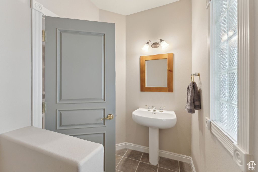 Bathroom featuring baseboards and tile patterned flooring