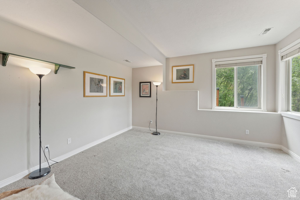 Empty room featuring carpet and baseboards