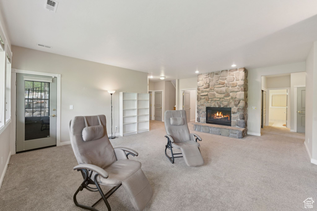 Carpeted living room with a fireplace, baseboards, and recessed lighting
