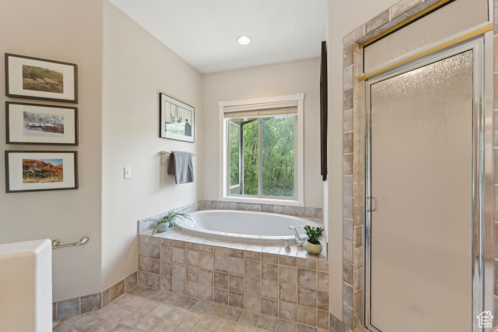 Full bathroom with a garden tub and a stall shower