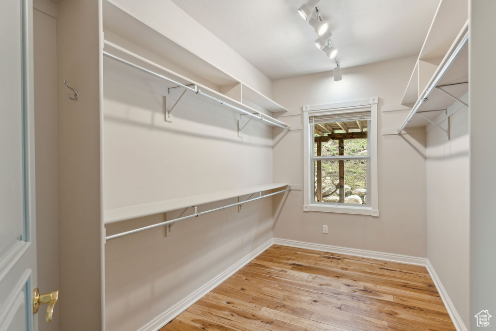 Walk in closet featuring light wood finished floors