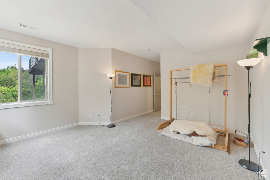 Interior space featuring carpet flooring and baseboards