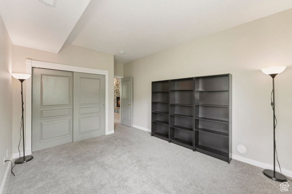 Unfurnished bedroom featuring carpet flooring, baseboards, and a closet