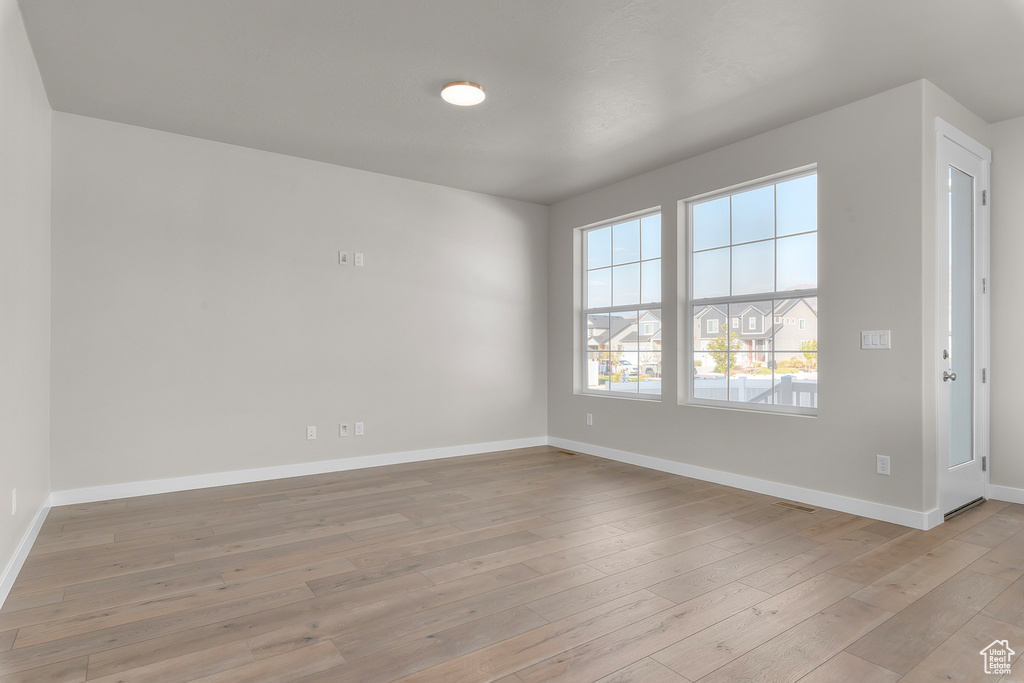 Empty room featuring light wood-type flooring and baseboards