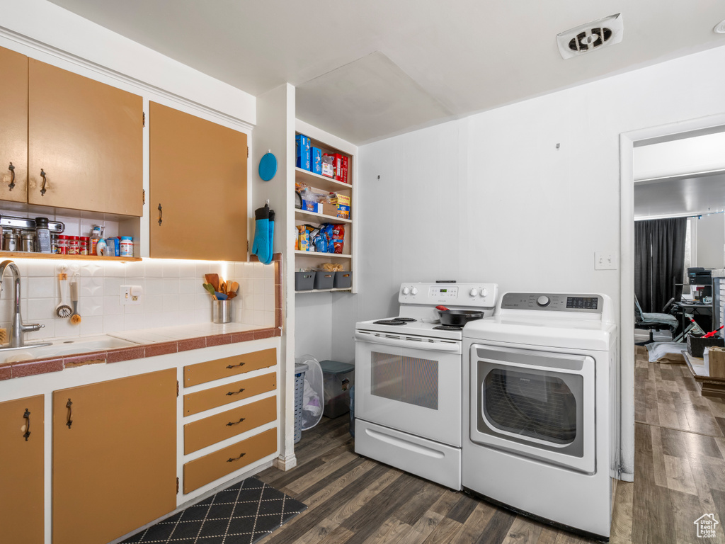 Washroom featuring washer / clothes dryer and dark wood-type flooring