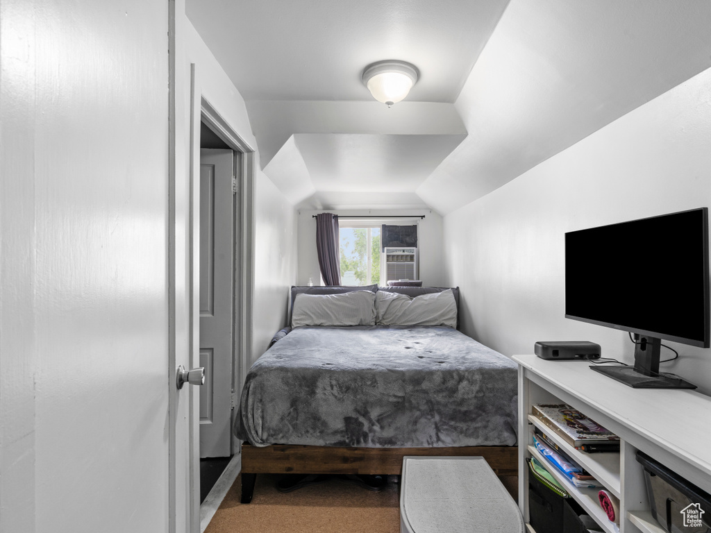Bedroom with lofted ceiling