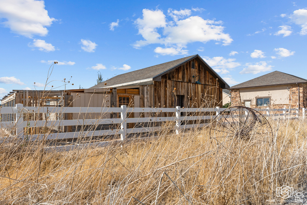 View of barn with fence