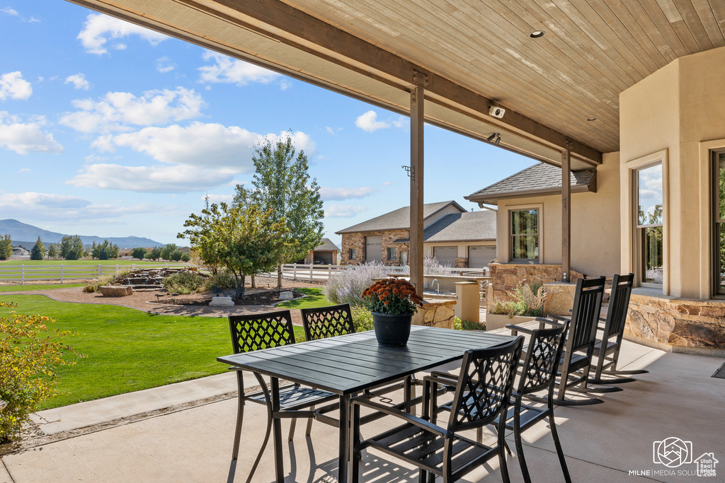 View of patio / terrace with outdoor dining space and a mountain view