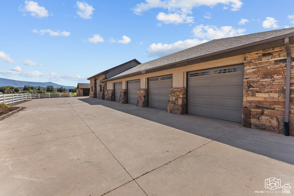 Garage featuring a mountain view and fence