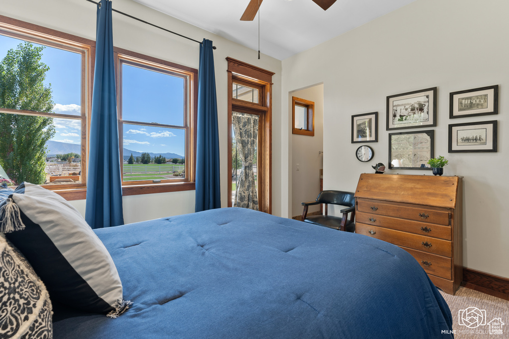 Bedroom with carpet flooring, baseboards, and ceiling fan