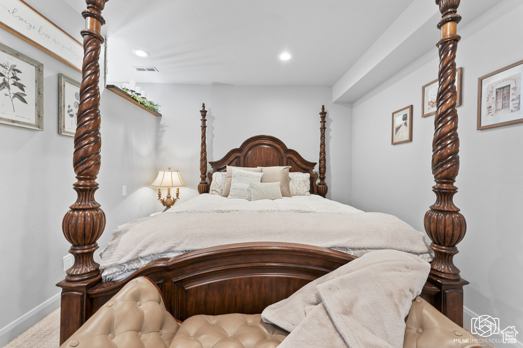Carpeted bedroom with baseboards and recessed lighting