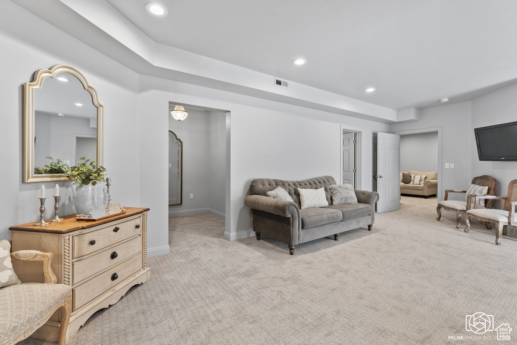 Living room featuring light carpet, recessed lighting, and baseboards