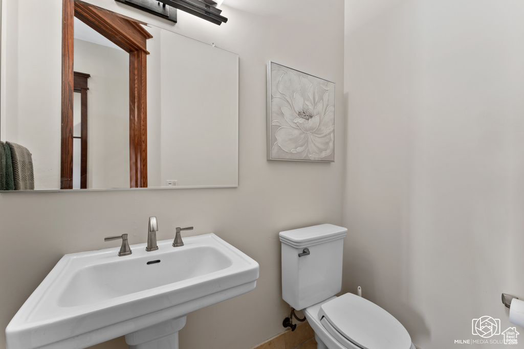 Half bathroom featuring a sink and toilet