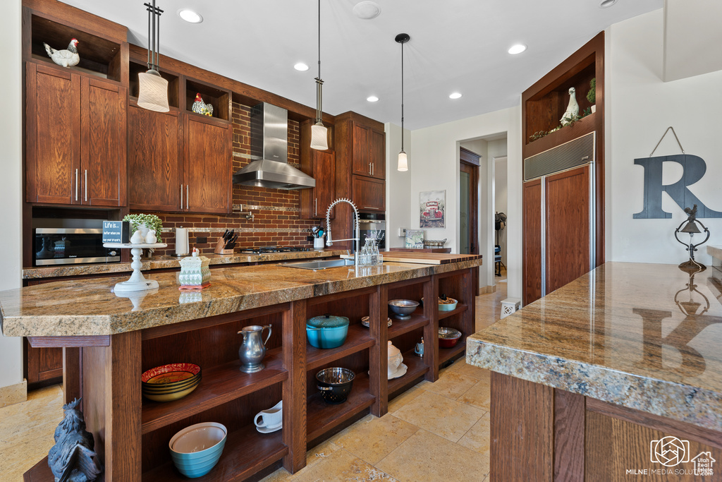 Kitchen featuring open shelves, wall chimney range hood, tasteful backsplash, a sink, and recessed lighting