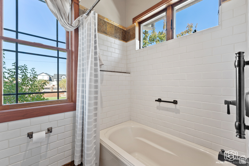 Bathroom featuring shower / bath combination with curtain