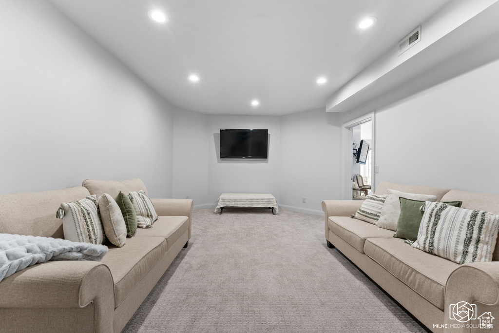 Living area featuring recessed lighting, carpet, and baseboards