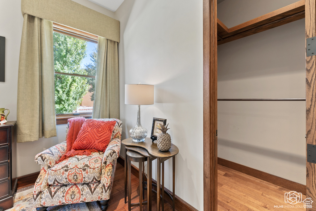 Living area with baseboards and wood finished floors