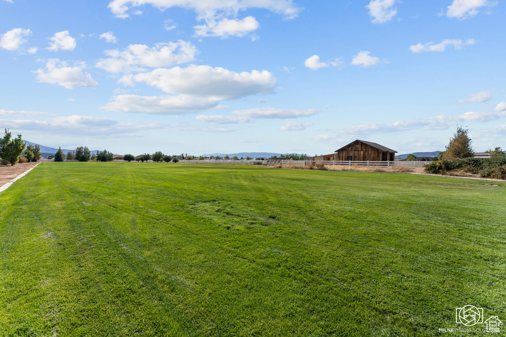 View of grassy yard with a barn and an outdoor structure