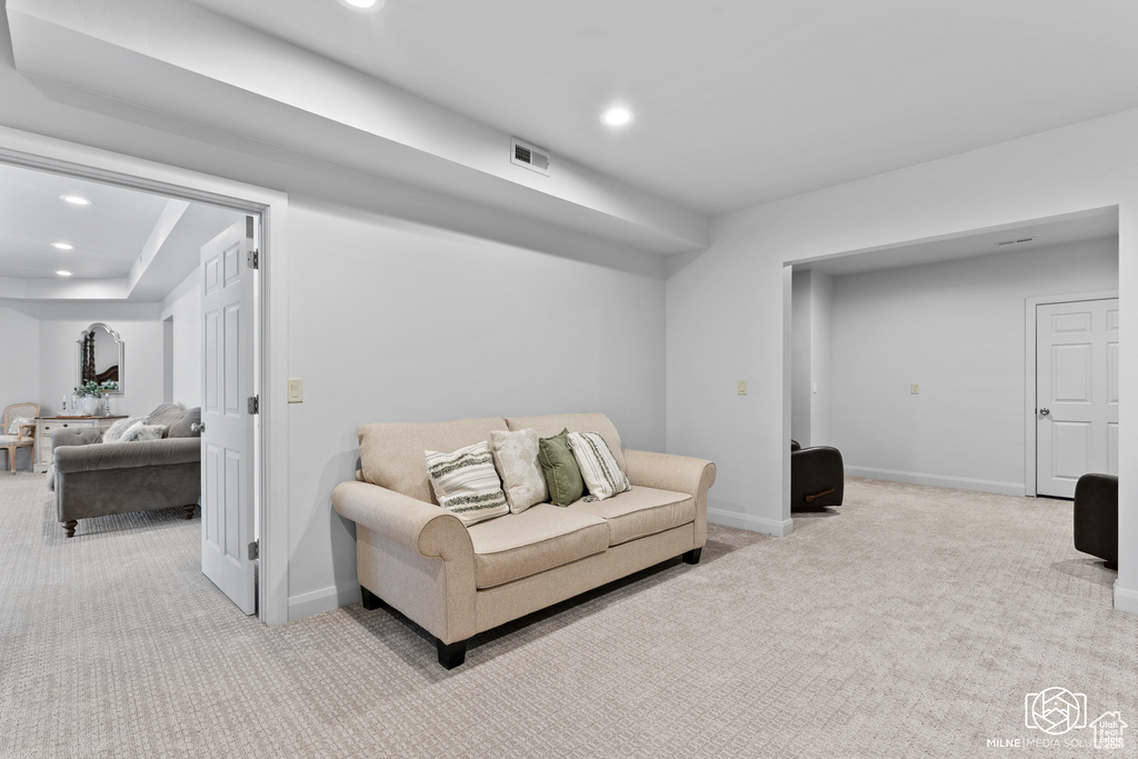 Living room featuring carpet, recessed lighting, and baseboards