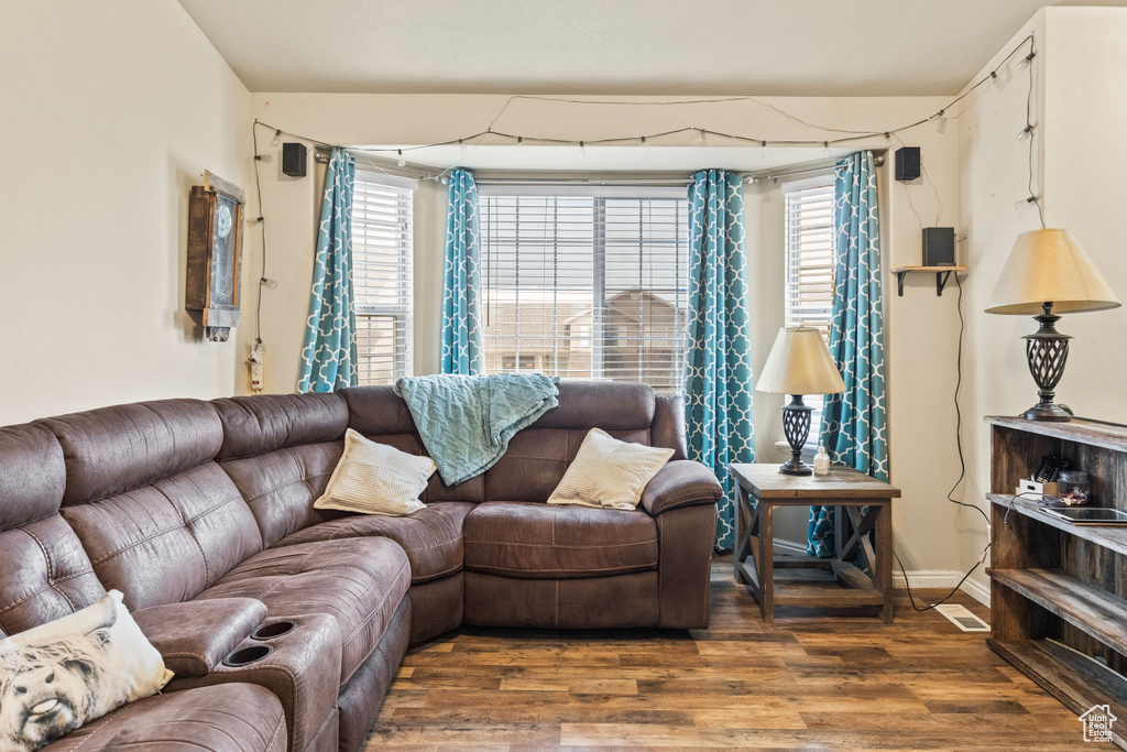 Living area with wood finished floors and baseboards