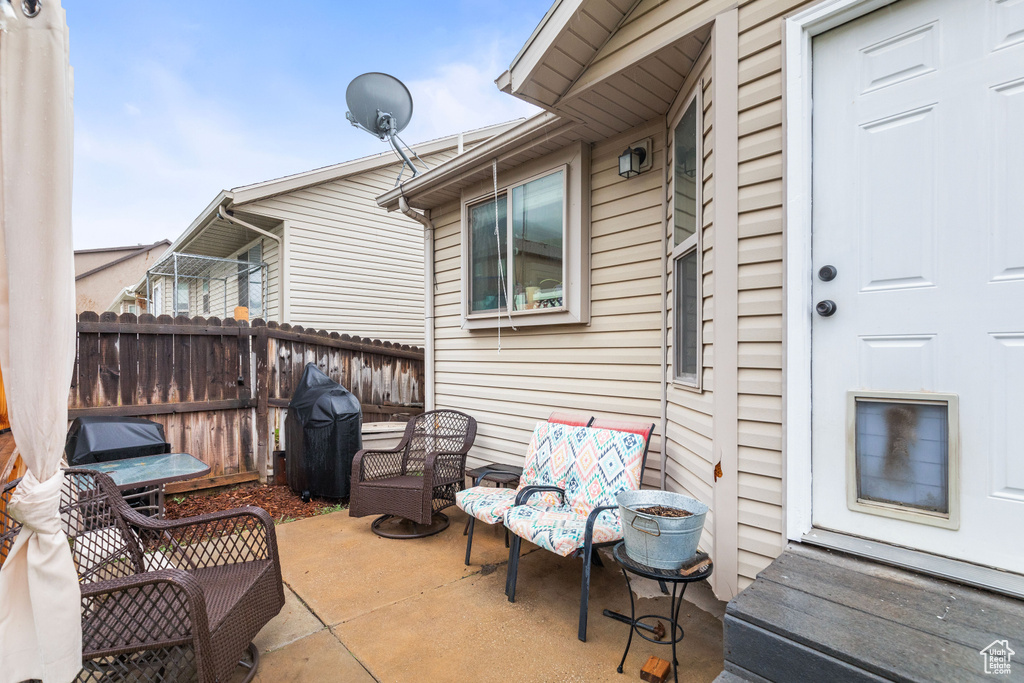 View of patio / terrace with fence and a grill