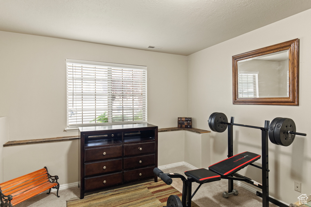 Workout area with carpet flooring and baseboards