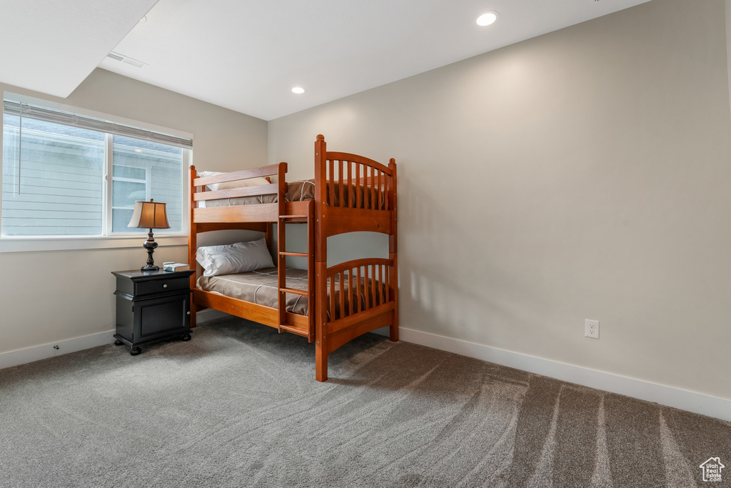 Bedroom with carpet floors, baseboards, and recessed lighting