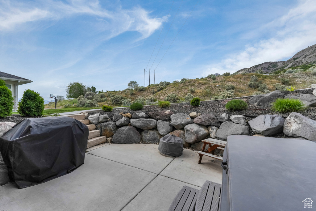 View of patio with a grill