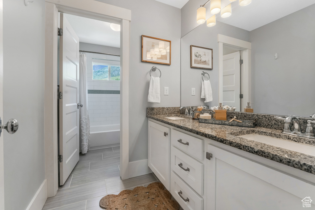 Bathroom with baseboards and double vanity