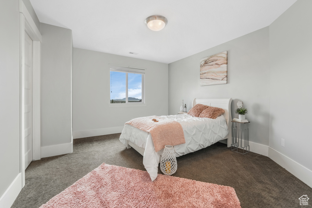 Bedroom featuring carpet floors and baseboards