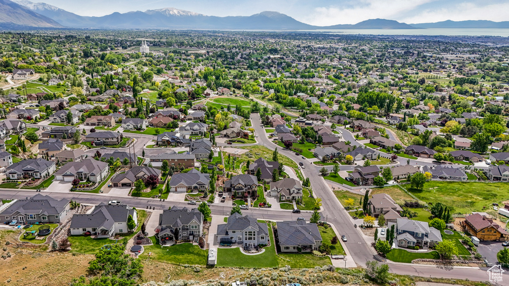 Aerial perspective of suburban area featuring a mountainous background