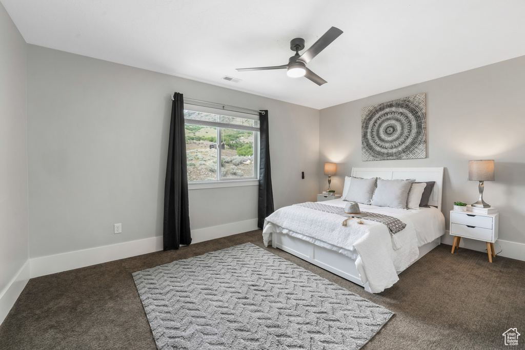 Bedroom featuring carpet, baseboards, and ceiling fan