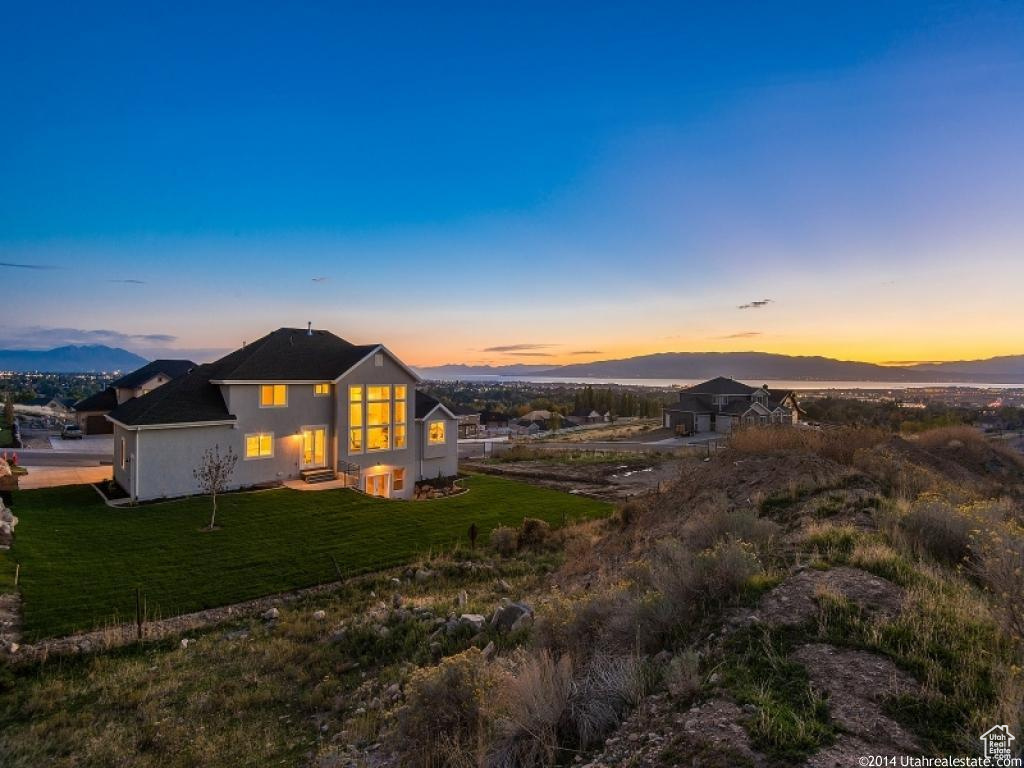 View of front of house featuring a lawn and a mountain view