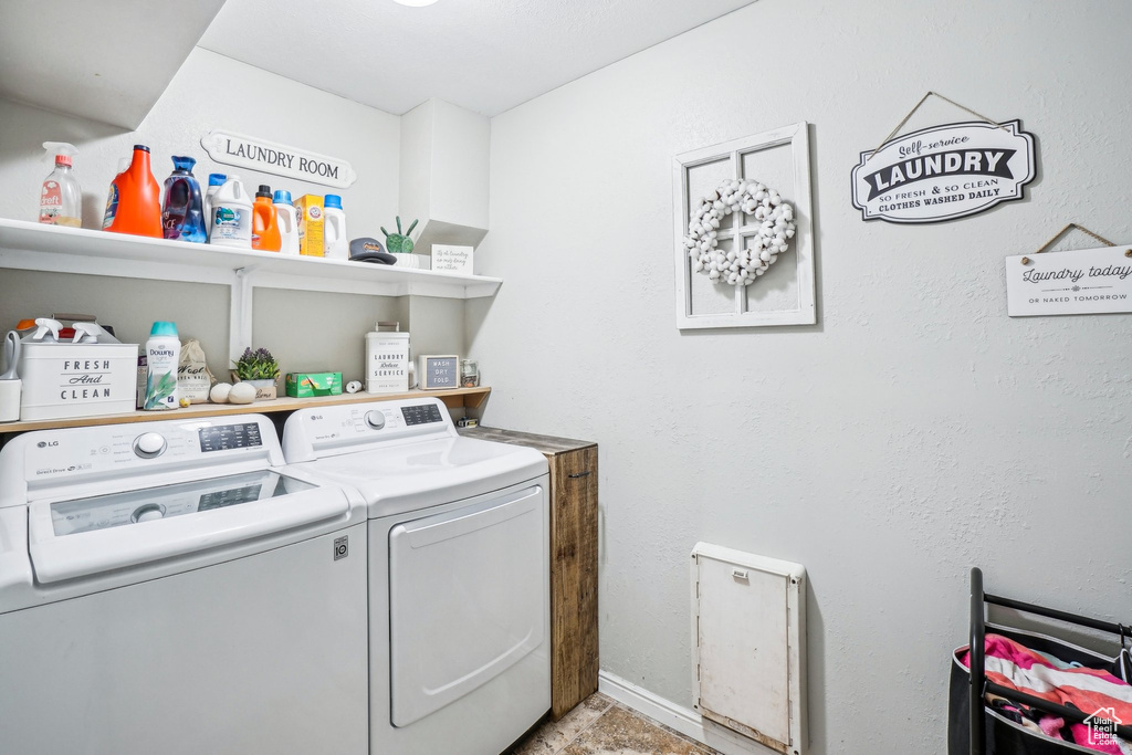 Clothes washing area with separate washer and dryer and baseboards