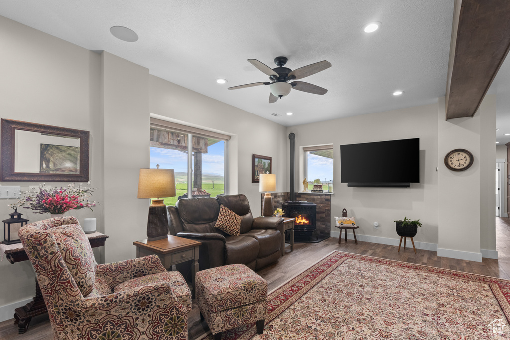 Living room featuring wood finished floors, ceiling fan, recessed lighting, and baseboards