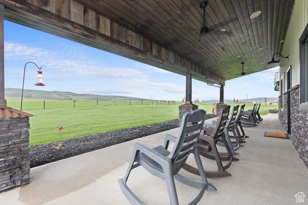 View of patio featuring ceiling fan and a rural view