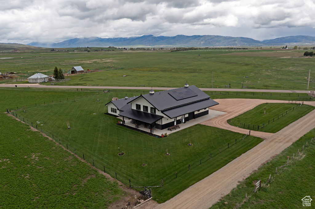 View of rural area with agricultural land and a mountainous background