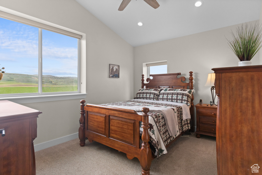 Bedroom with light colored carpet, recessed lighting, vaulted ceiling, ceiling fan, and baseboards