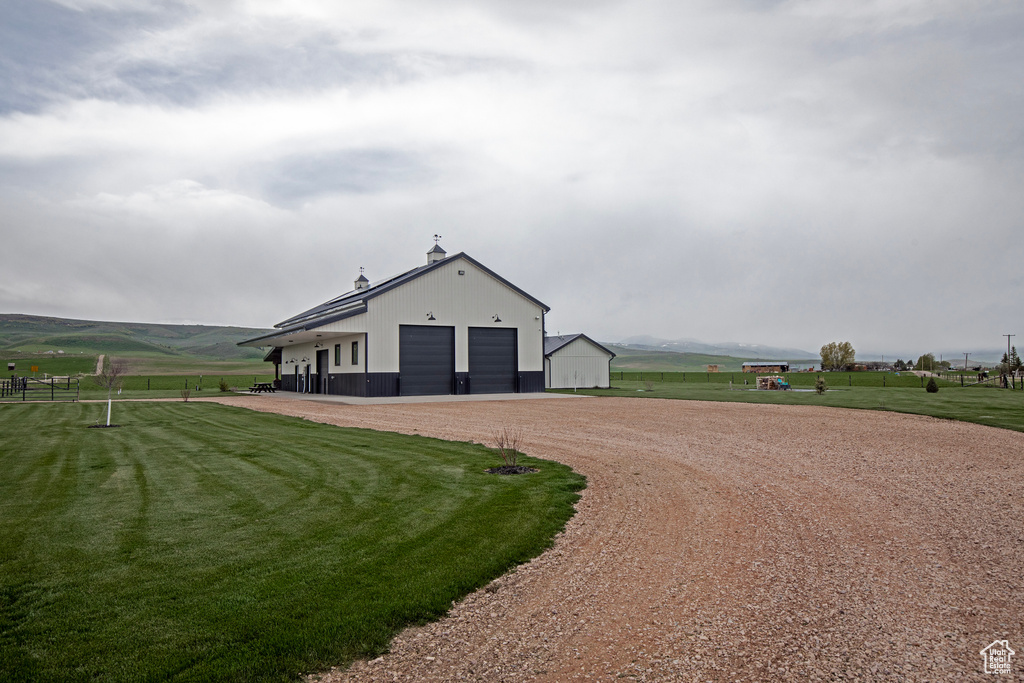 View of outdoor structure featuring driveway, an outdoor structure, and a view of countryside