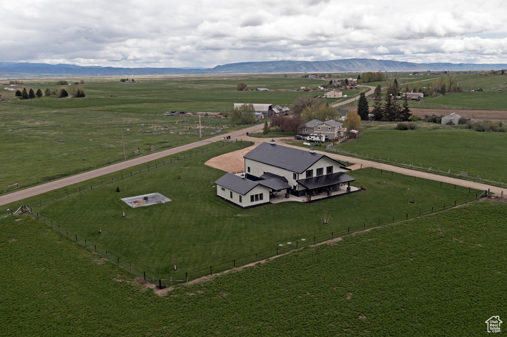 Overview of rural landscape featuring a mountain backdrop and a pastoral area