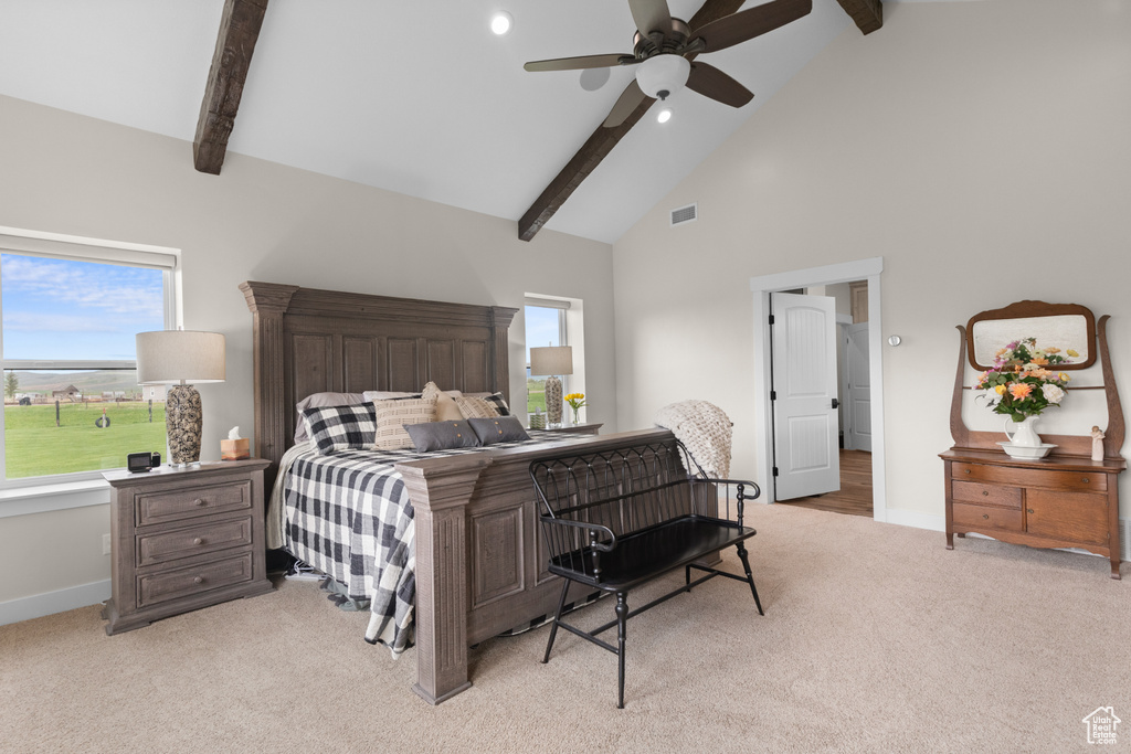 Bedroom featuring light colored carpet, beamed ceiling, high vaulted ceiling, baseboards, and a ceiling fan
