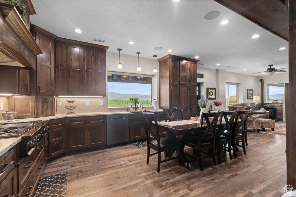 Kitchen featuring stainless steel dishwasher, gas stovetop, ceiling fan, light wood-style floors, and recessed lighting