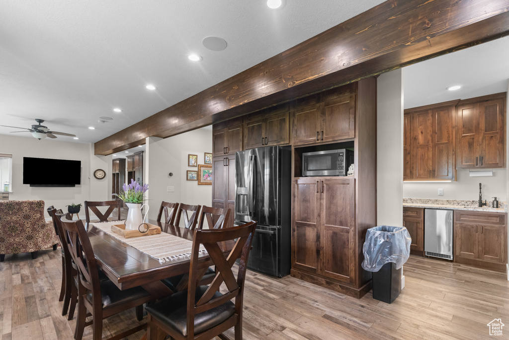 Dining room featuring recessed lighting, light wood finished floors, a ceiling fan, and bar area